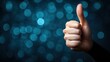 © Balerinastock - Thumbs Up!  Positive Gesture Against a Teal Bokeh Background
