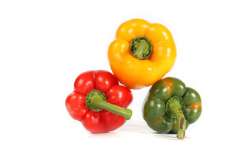 a trio of fresh bell peppers green, red, and yellow isolated on white background