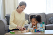 © peopleimages.com - Psychologist, child and development with toys for education, learning behavior and assessment for adhd. Therapy, mature therapist and girl with blocks for autism, sensory skills and cognitive game