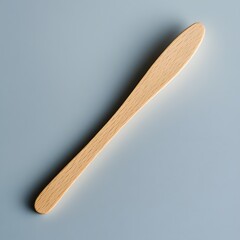 Poster - Tongue depressor isolated on a minimalist background wooden and straight with clean lines showing its utility in medical exams
