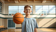 © SusDmi - Portrait happy boy holding basketball in a school gymnasium , with white tonespng
