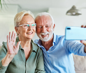 Wall Mural - senior woman man couple elderly love elderly selfie camera mobile phone smartphone photo picture portrait male old together active vitality cell phone hug