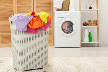 Wall Mural - Wicker basket full of laundry in bathroom