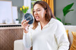 © dragonstock - Young woman looking at her teeth in the mirror
