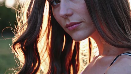Poster - A romantic, golden-hour photograph in which her deep brown eyes catch the glow of sunset, her long hair cascading around her shoulders as she looks on.