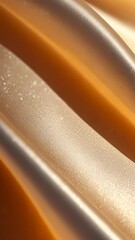 Poster - An abstract animation showcases flowing forms and glimmering surfaces, creating a soothing visual experience. The warm color palette enhances the gentle movement and depth