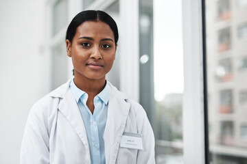 Poster - Portrait, doctor and Indian woman in clinic, healthcare and confidence with career ambition. Face, person and employee with pride, natural medicine and medical with professional and wellness center