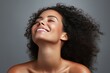 © polack - Beautiful smiling afro woman touching her flawless glow, perfect skin care and confidence