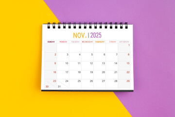 Wall Mural - November 2025 Monthly desk calendar for 2025 year on yellow and purple.