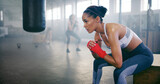 Woman, boxer thinking and gym for fitness goals, sports break and athlete for contemplating fight. Female person, martial arts ideas and club for progress, training rest and ponder on performance
