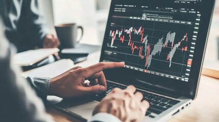 Poster - Businessman pointing at financial chart displayed on laptop screen, analyzing market trends and investment opportunities during a productive workday in the office
