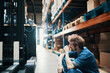 © Davor - Warehouse worker taking a break sitting near forklift in storage facility