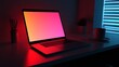 © @adha - Laptop with a colorful screen, coffee cup, and pencils on a desk in a red and blue lit room