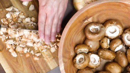 Wall Mural - Cooking stuffed Portobello mushrooms as an appetizer. For a side dish making stuffed Portobello mushrooms with fresh ingredients like mushrooms, cheese, onion and herbs.  Food preparation.