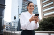 © peopleimages.com - Lawyer, smile or businesswoman in city with phone or online connection for text message or social media chat. Outdoor, happy or legal advisor typing on mobile app for reading good news notification