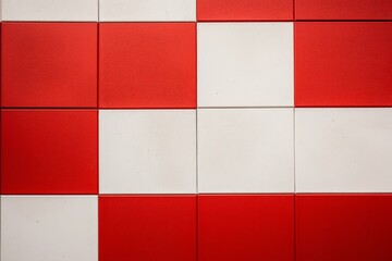 Leinwandbilder - Close up view of a checkered wall featuring alternating red and white squares, forming a striking visual pattern