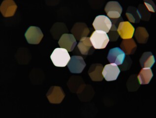 colourful hexagonal bokeh light overlay with blurred geometric pattern, film grain effect on a dark 