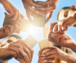 Leinwandbilder - People, hands and below with phone for network, communication or data sync under blue sky. Low angle, closeup or group with mobile smartphone for connectivity, social media or global software app