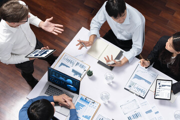 Fototapete - Top view analyst team utilizing BI Fintech to analyze financial data at table in meeting room. Analytic BI dashboard power on paper for business insight and strategic marketing planning. Prudent
