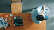 © Summit Art Creations - Top down view of businessman talking phone with team while sitting on table. Smart manager speaking and calling with colleague about marketing strategy while looking at financial graph. Convocation.