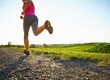 © peopleimages.com - Woman, running and legs with dirt road for fitness, cardio workout or outdoor exercise in nature. Back view, female person or runner with gravel trail or mockup space for sprint, race or training