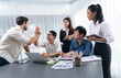 © InfiniteFlow - Diverse group of office employee worker high five after making agreement on strategic business marketing planning. Teamwork and positive attitude create productive and supportive workplace. Prudent