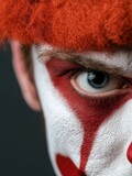 Creepy male clown with serious expression isolated on white background