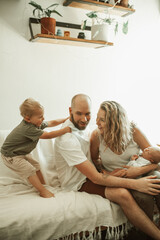 Sticker - Parents, children and a playful family on the sofa in the living room of their home together for bonding. Mother, father and kids in the house with a baby and cute boy child having fun in the lounge