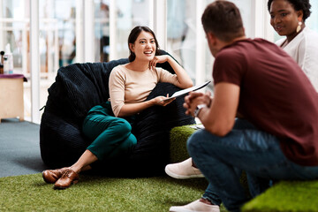 Poster - Business people, meeting and discussion with bean bag for creative brainstorming, planning or project at office. Happy, group or designers with smile for collaboration, sharing ideas or conversation