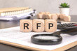 © Maks_Lab - RFP- Request For Proposal word written on a wooden block with magnifier and calculator, business concept.