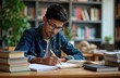 © miss irine - Indian student sits at desk in library environment diligently studying. Actively organizing textbooks, taking notes. Student appears focused, determined. Wears glasses, engaged in serious academic