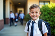 © miss irine - Happy little boy ready for first grade. Stands outdoors near school building. Smiling boy wearing school uniform with backpack. School supplies. Education. Back to school. Child excited. Cute,
