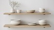 © Giman - Minimalist ceramic bowls and plates arranged on wooden floating shelves against a white wall.