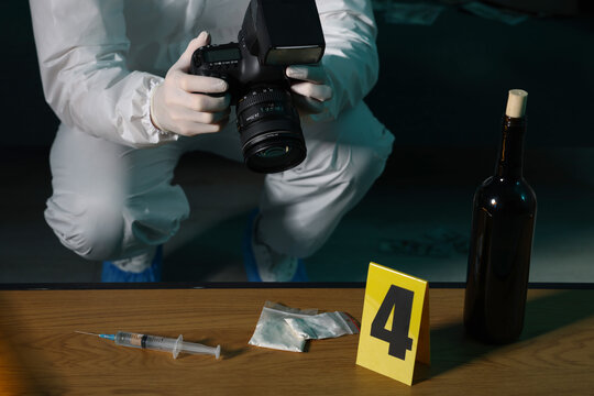 Wall Mural -  - forensic expert with camera taking photo of evidences at crime scene indoors, closeup