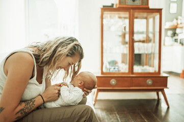 Sticker - Mother, holding baby and happy in home for love, care and bonding together. Mama, newborn smile and cute kid, infant or toddler in comfort, relax and playing while enjoying quality time in house.