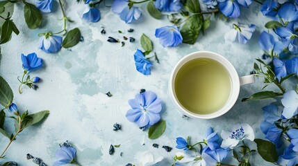 Poster - Top view of a creative workspace with blue flowers, green tea, and a white keyboard, framed with copy space.
