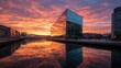 © Sirinya - A contemporary glass building reflecting the golden hues of a sunset, with the sky painted in warm orange and pink tones.