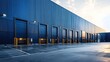 © Rangga Bimantara - Blue warehouse exterior with loading docks at sunset