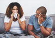 © peopleimages.com - Stress, couple and sick woman in home with sneezing, spread germs and partner frustrated by allergies. African people, risk and tissue for runny nose with viral infection, flu symptoms and sinusitis