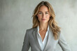 © Vibu design  gallery - Confident businesswoman in a grey suit, exuding professionalism and success.