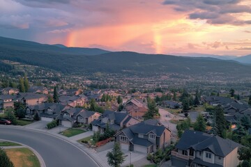Poster - Sunset glow illuminates suburban homes with a rainbow over mountains in the distance, Sunset glow on suburban homes and rainbow in mountain - drone, tracking shot