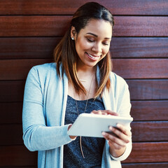 Leinwandbilder - Business woman, tablet and happy by wall, reading and click for contact at startup media company. Person, writer and digital touchscreen on application, smile or project management at creative agency