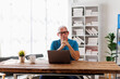 © David - Senior, man and happy with portrait, Businessman using laptop computer in office. Happy middle aged man, entrepreneur, small business owner working online.