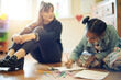 © peopleimages.com - Psychologist woman with child color drawing for assessment, evaluation or support of mind development. Creativity, writing and biracial people and kid on floor talking, helping and teaching therapy