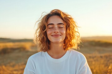 Poster - young woman smiling gently while sitting in meditation pose bathed in golden morning light