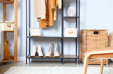 Wall Mural - Shelving unit with clothes and shoes in light room