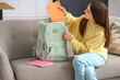© Pixel-Shot - Little schoolgirl with copybook in backpack at home