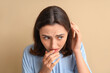© Pixel-Shot - Worried young woman with dandruff on beige background, closeup