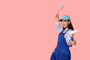 Wall Mural - female asian painter with rollers on pink background