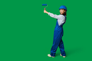 Wall Mural - female asian painter with roller on green background